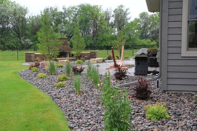 A house with a patio and a fire pit in the backyard.