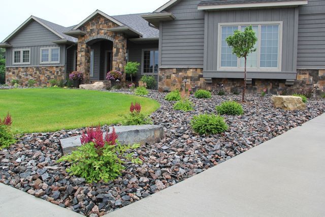A house with a lot of rocks in front of it
