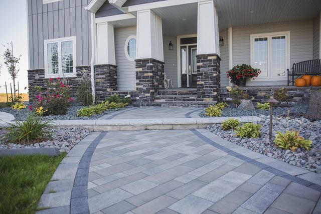 There is a walkway leading to the front of the house.