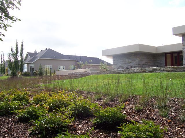 A house with a large lawn in front of it
