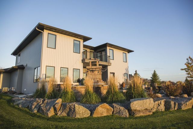A large white house with a fountain in front of it.