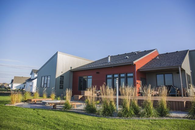 A row of houses are sitting next to each other on a lush green lawn.