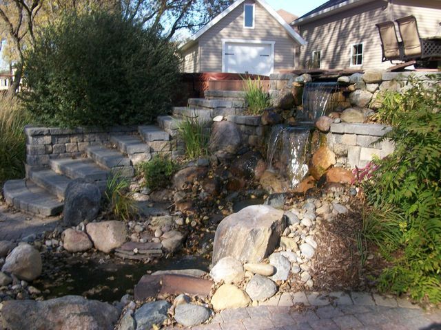 A house with a waterfall in front of it