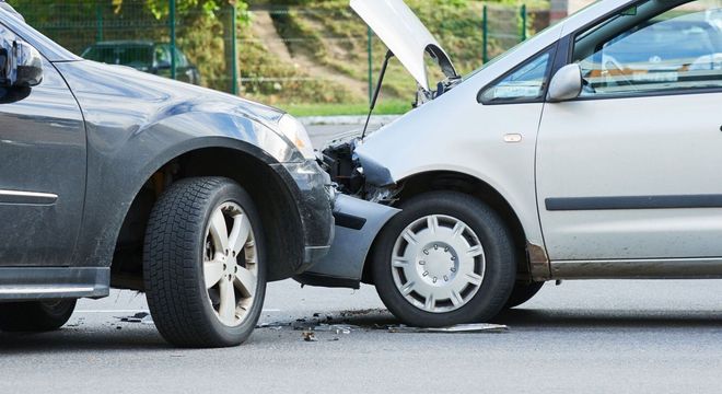 Two cars with crumpled front ends after a collision on a street