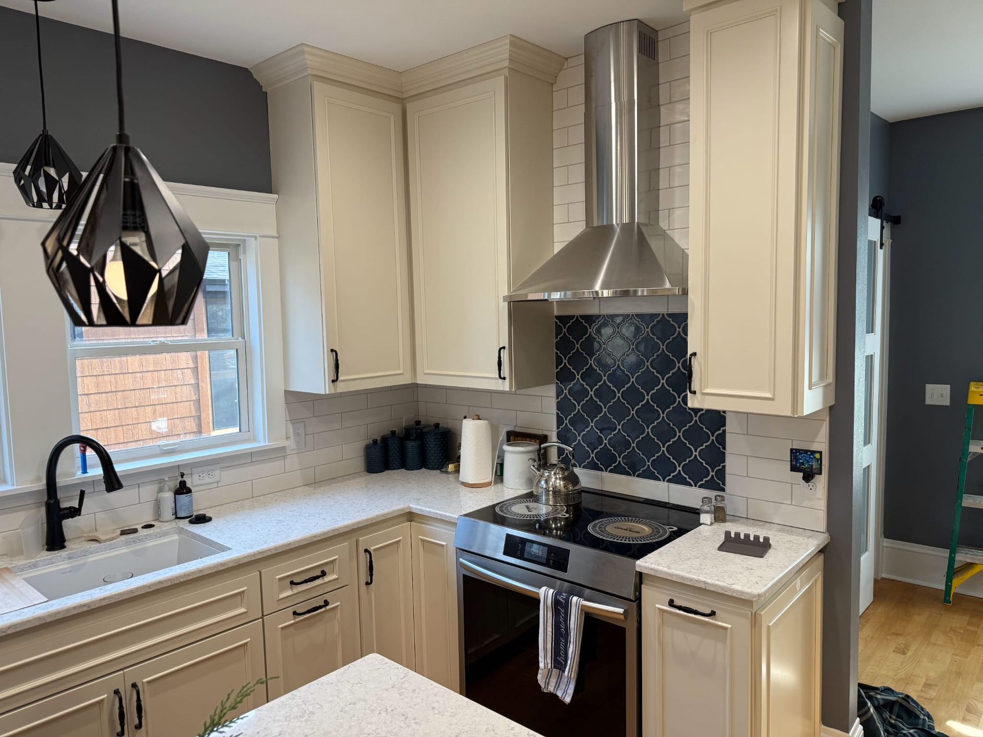 A kitchen with white cabinets and stainless steel appliances.