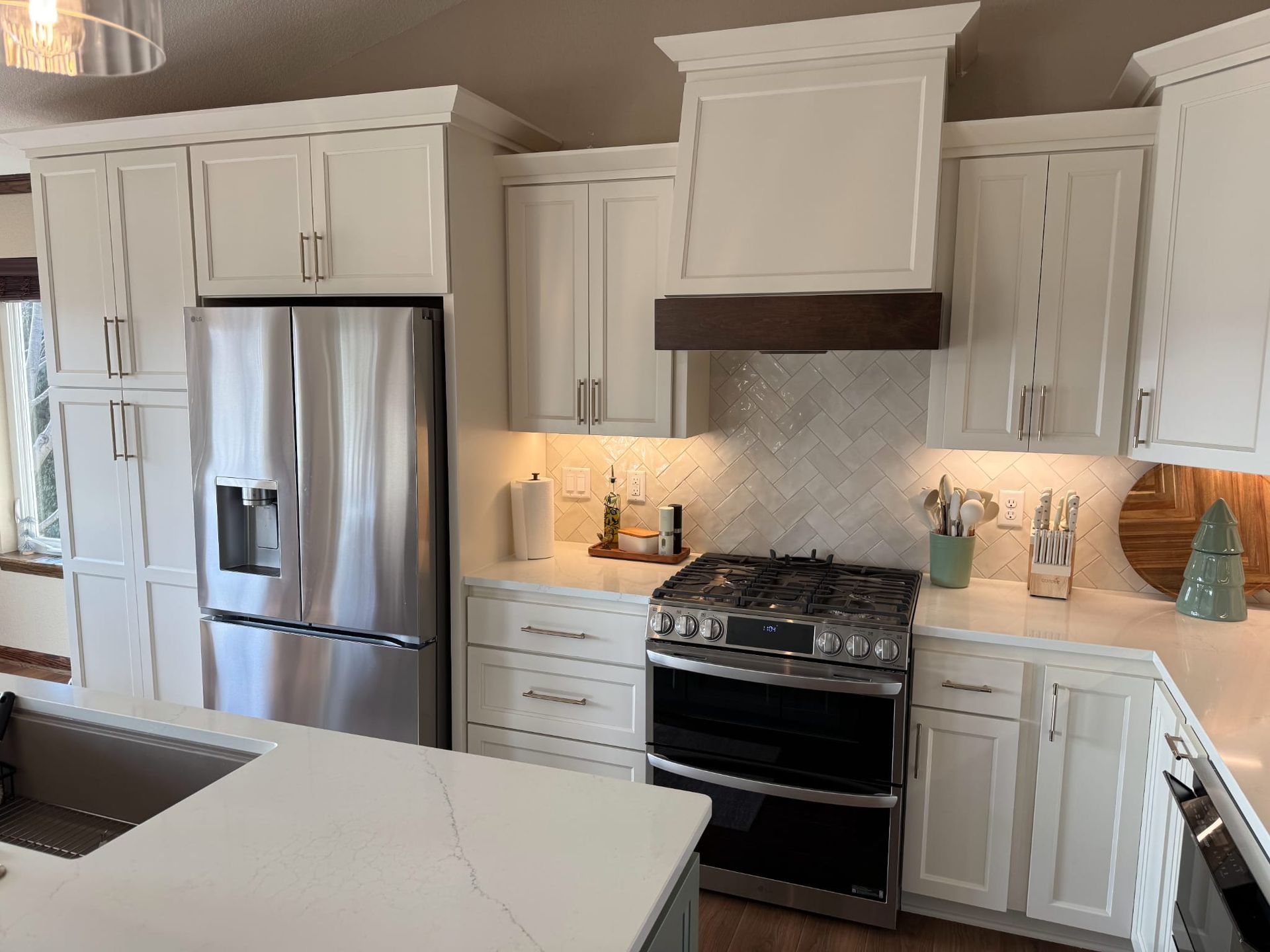 A kitchen with white cabinets and stainless steel appliances.
