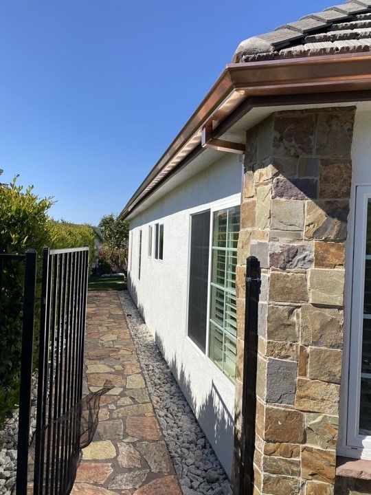 The side of a house with a walkway leading to it