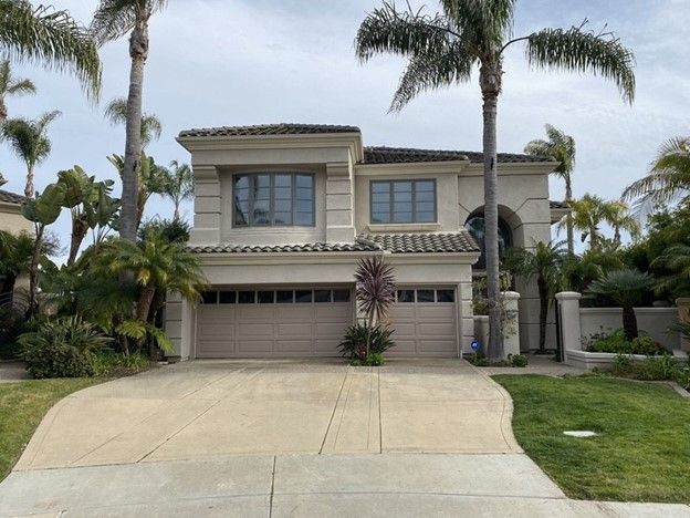 A large house with palm trees in front of it