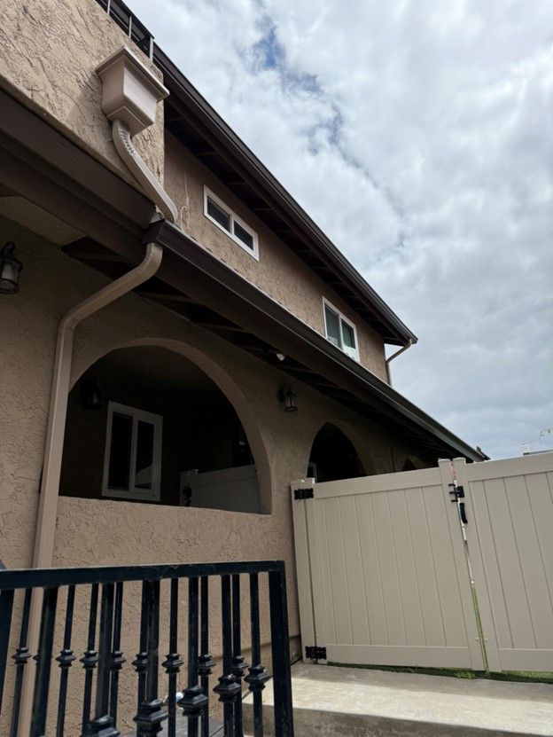 A house with a white fence in front of it