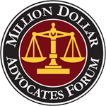 Million Dollar Advocates Forum logo with gold scales on a maroon circular seal