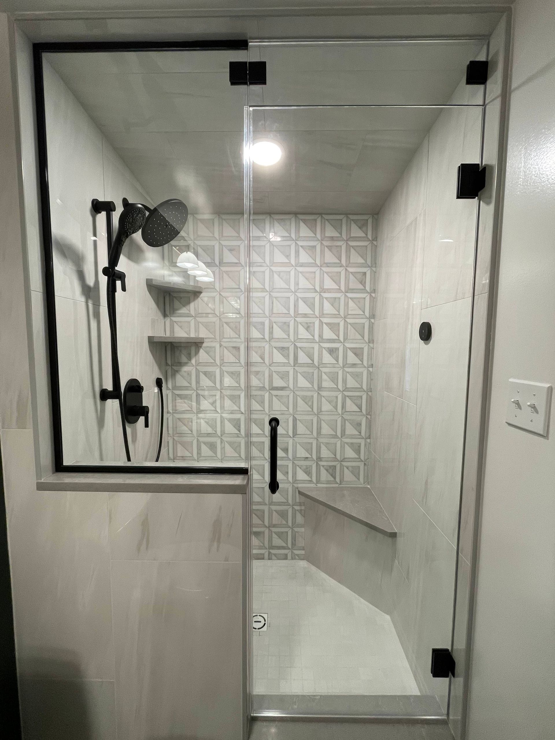 a bathroom with a glass shower door and a shower head