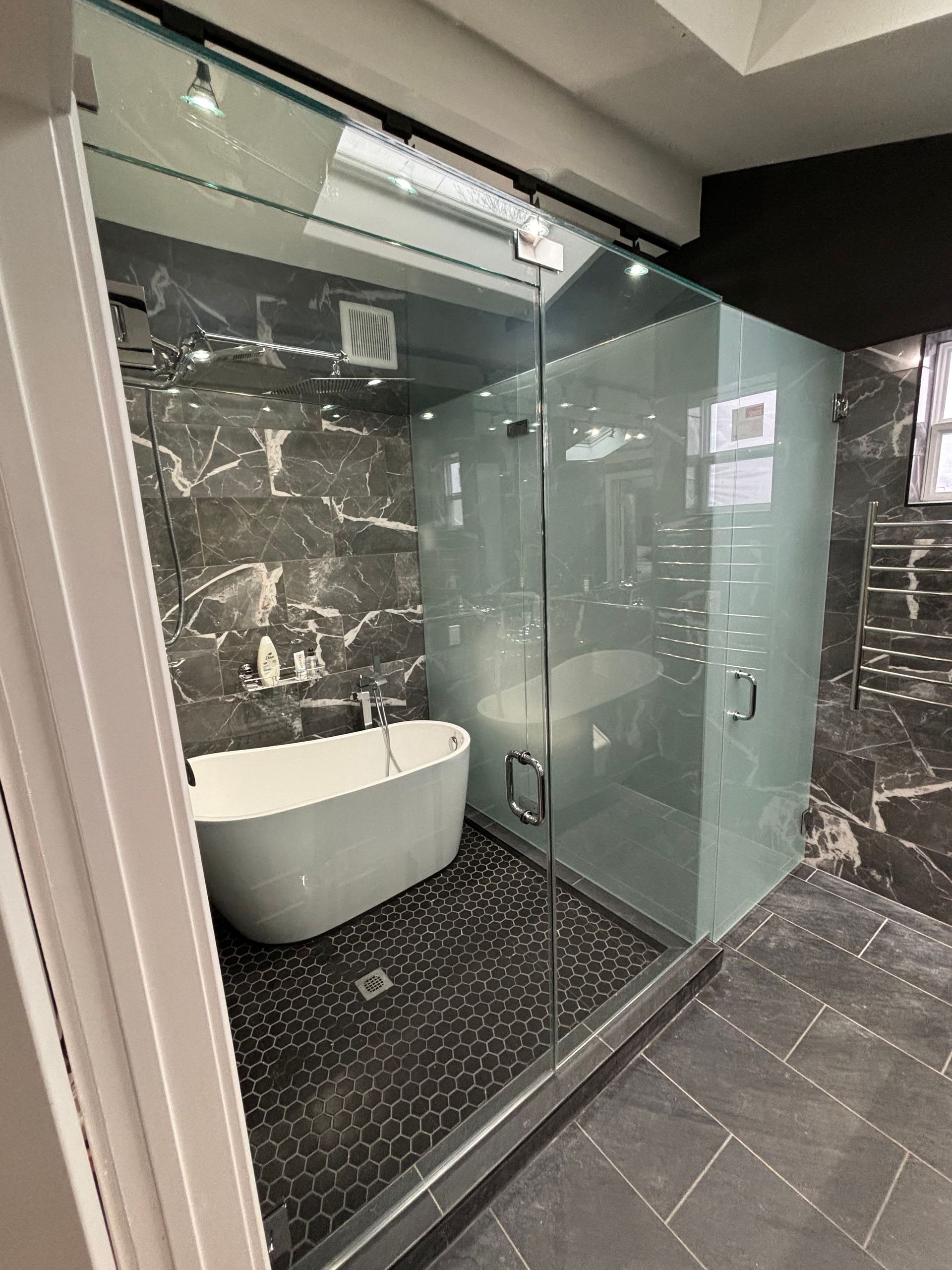 a bathroom with a bathtub and a walk in shower