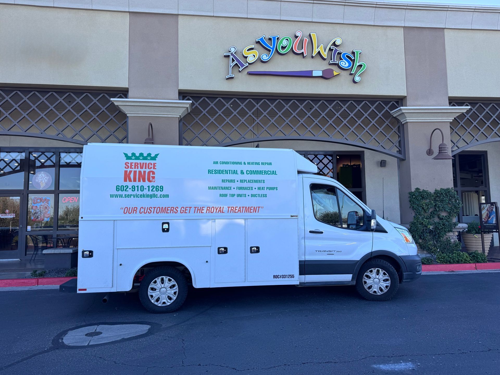 White service van parked outside a store named 