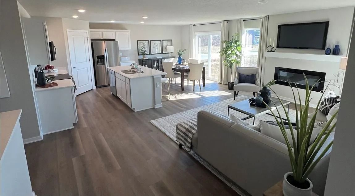 Open-concept living space with kitchen, dining area, and living room in a modern home.
