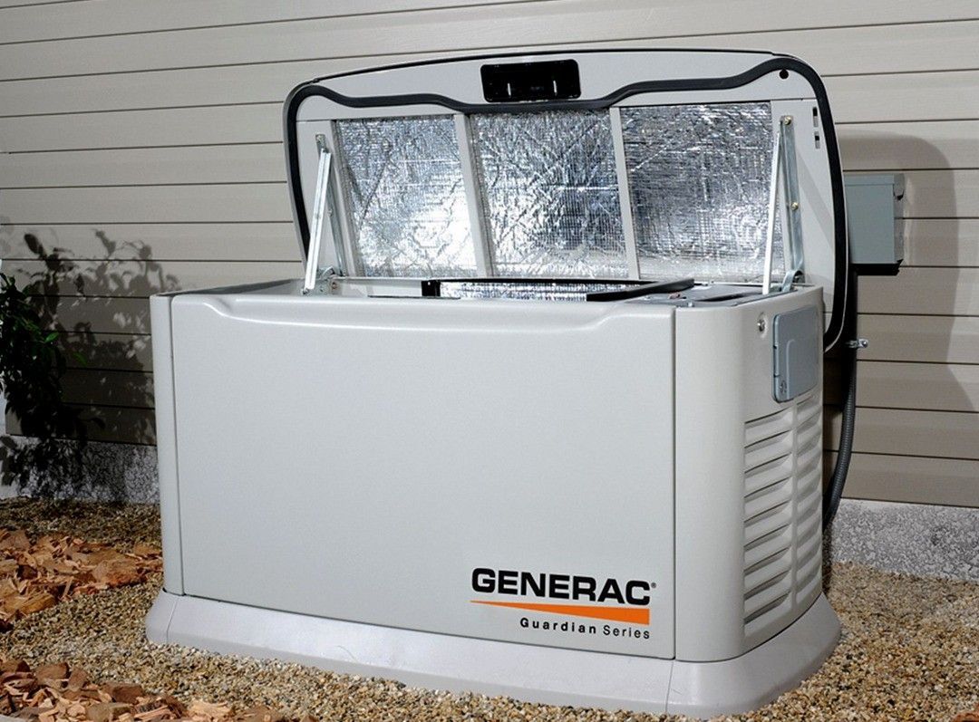 Open Generac generator with foil-lined lid in a backyard