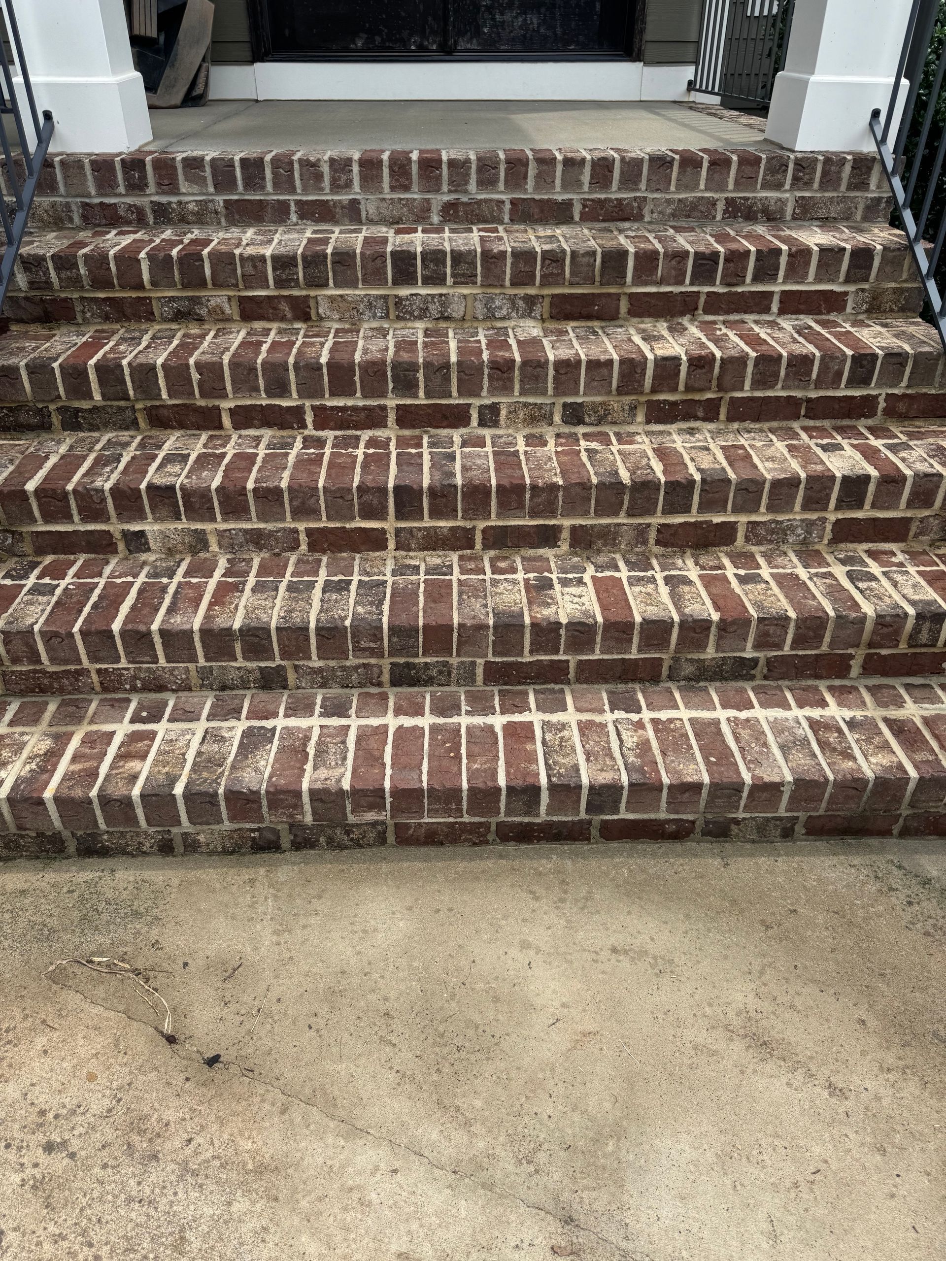 A set of brick stairs leading up to a house.