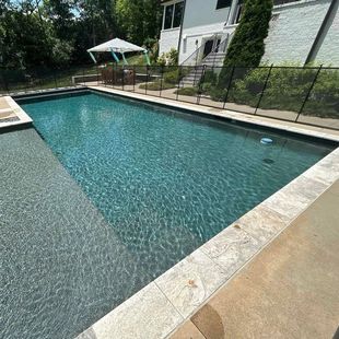 In-ground pool with poolside furniture