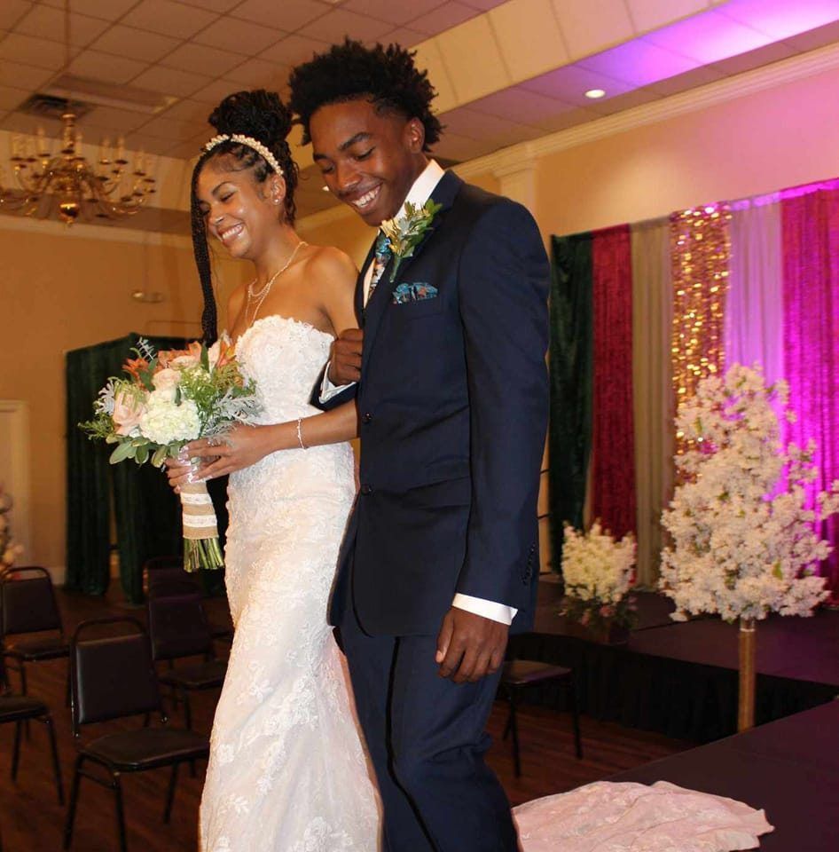 A bride and groom are walking down the aisle at their wedding.