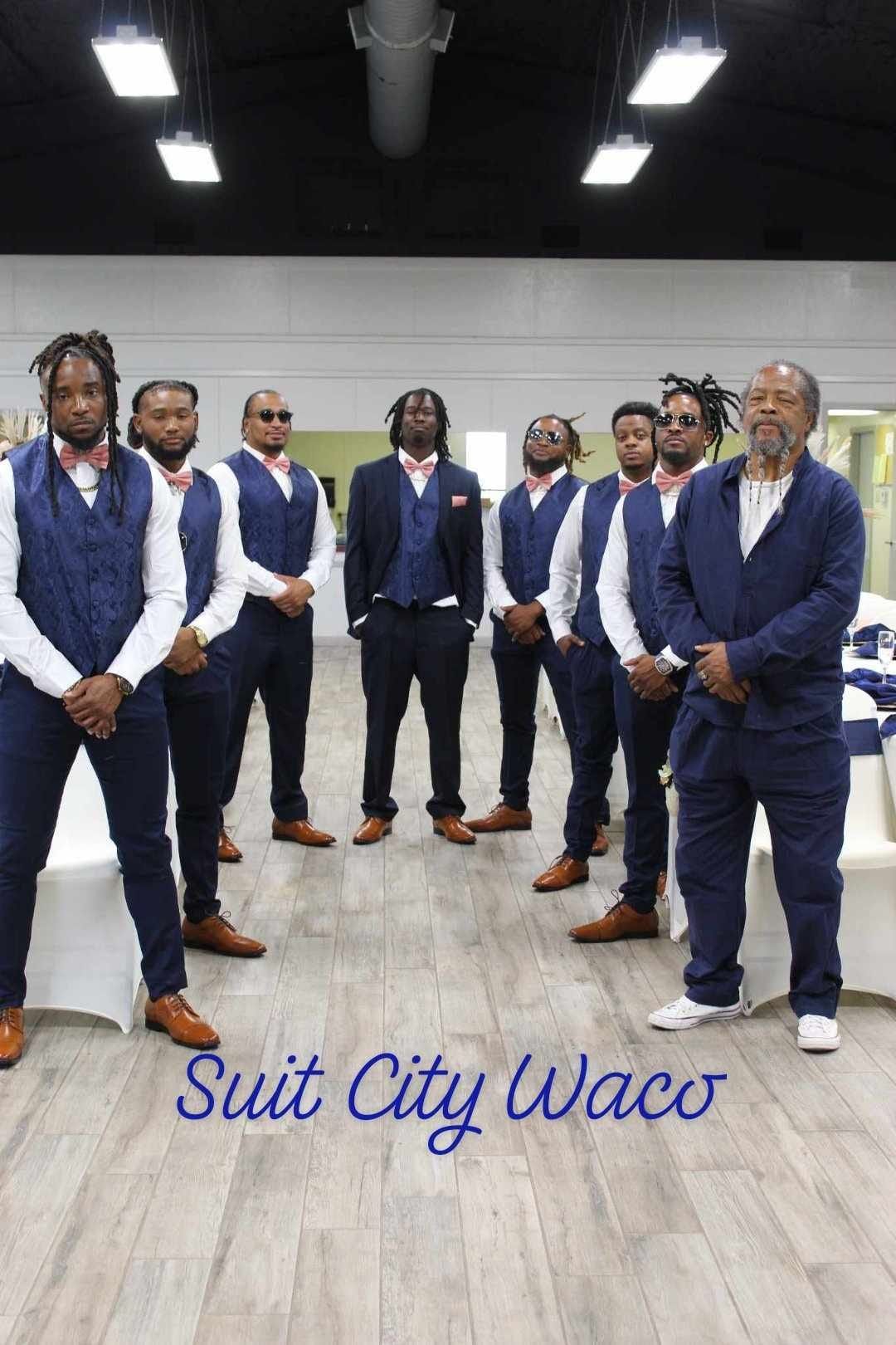 A group of men in suits are standing next to each other in a room.