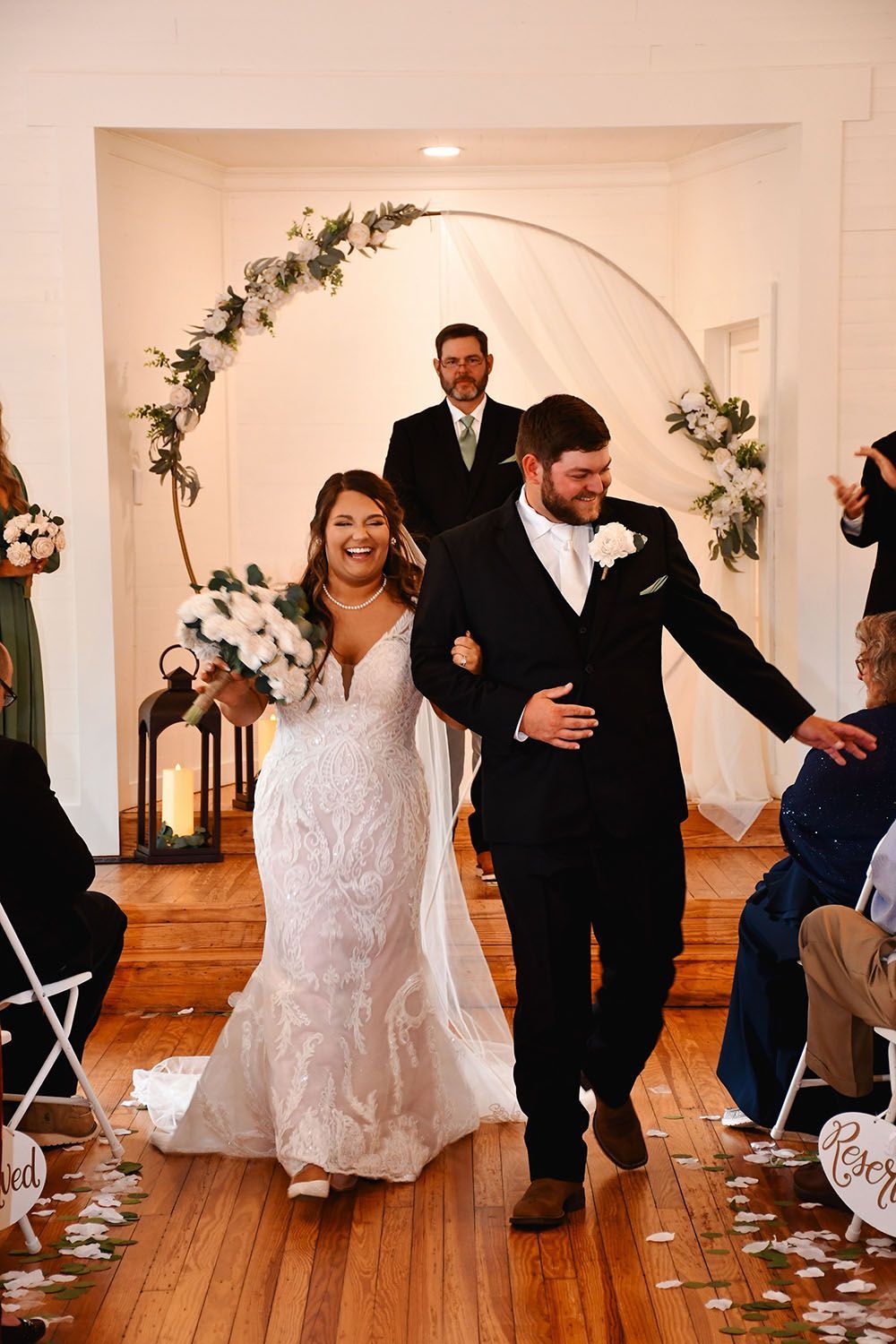 A bride and groom are walking down the aisle at their wedding.