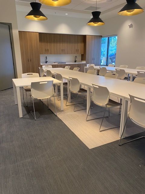 A large room with tables and chairs in it