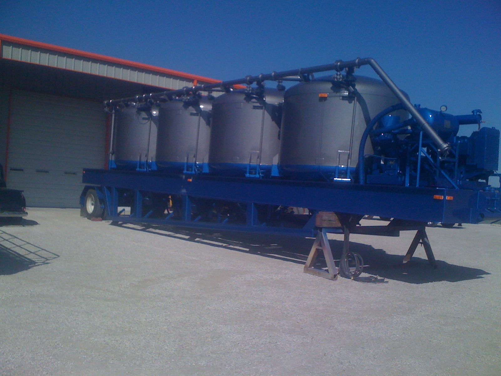 A blue trailer with a bunch of tanks on it