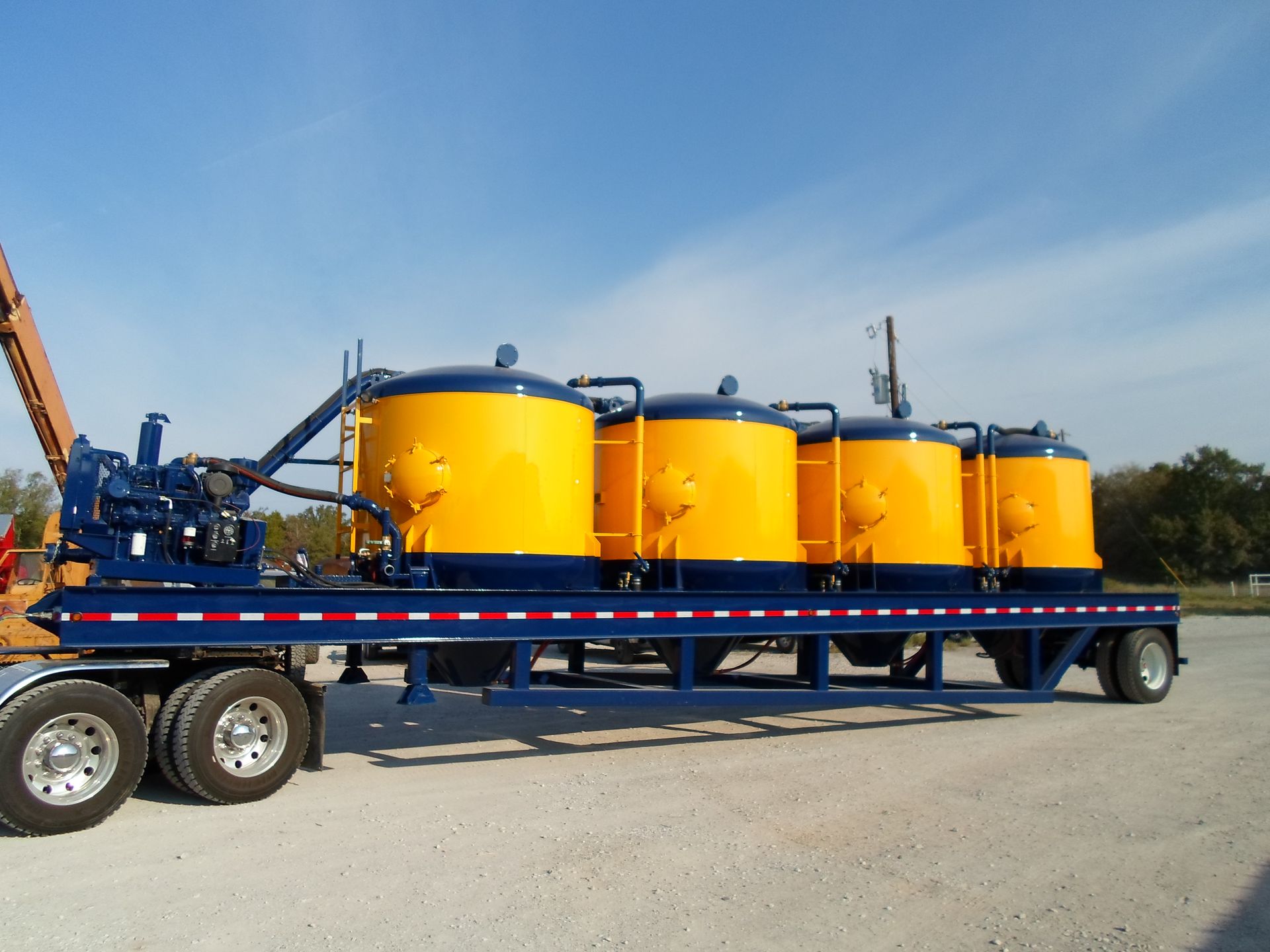 A blue trailer with yellow tanks on it