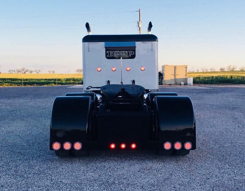 A black and white semi truck with a license plate that says ' s. burke ' on it