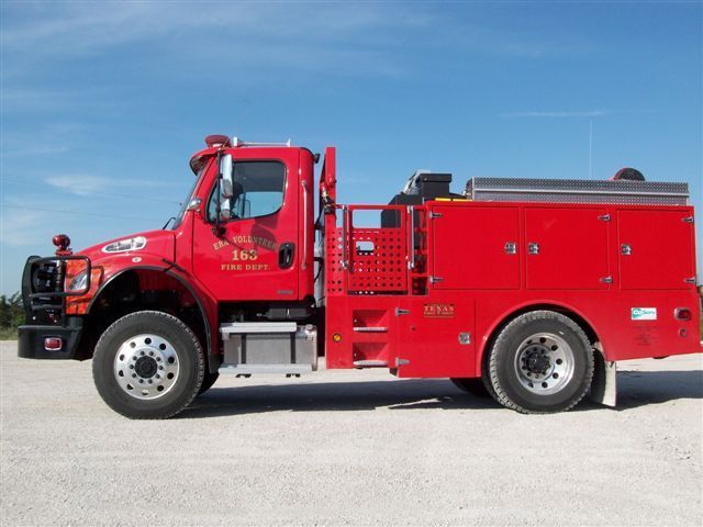 A red fire truck is parked on the side of the road