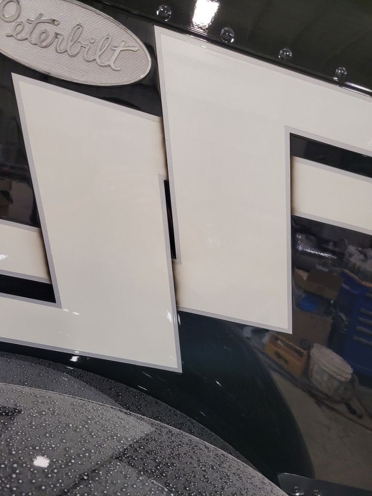 A close up of a peterbilt logo on a truck