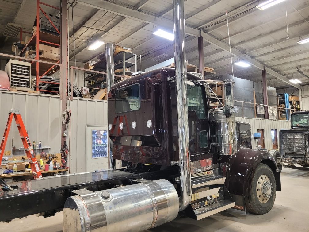 A large semi truck is parked in a warehouse.