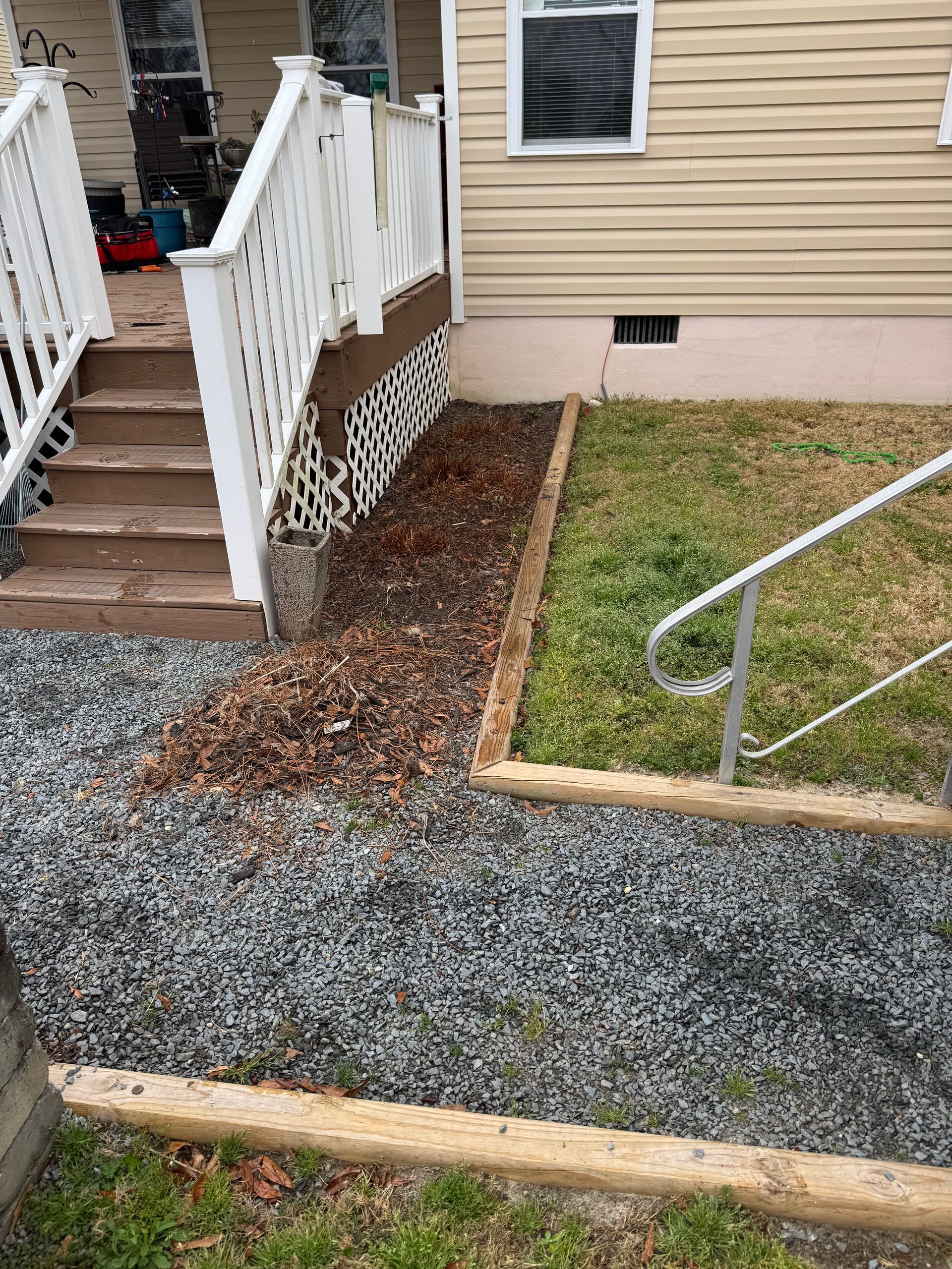 Exterior view of a house with steps and gravel pathway