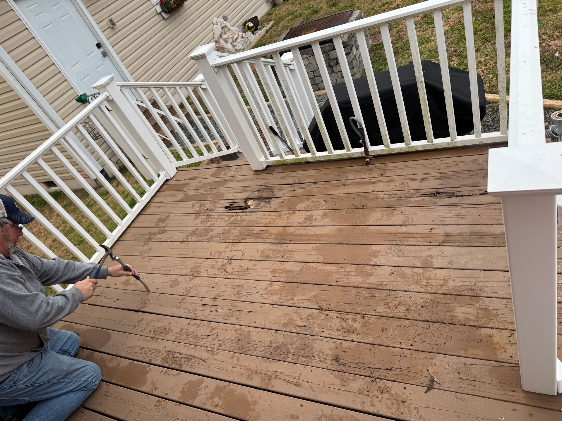 A wooden deck with white railing