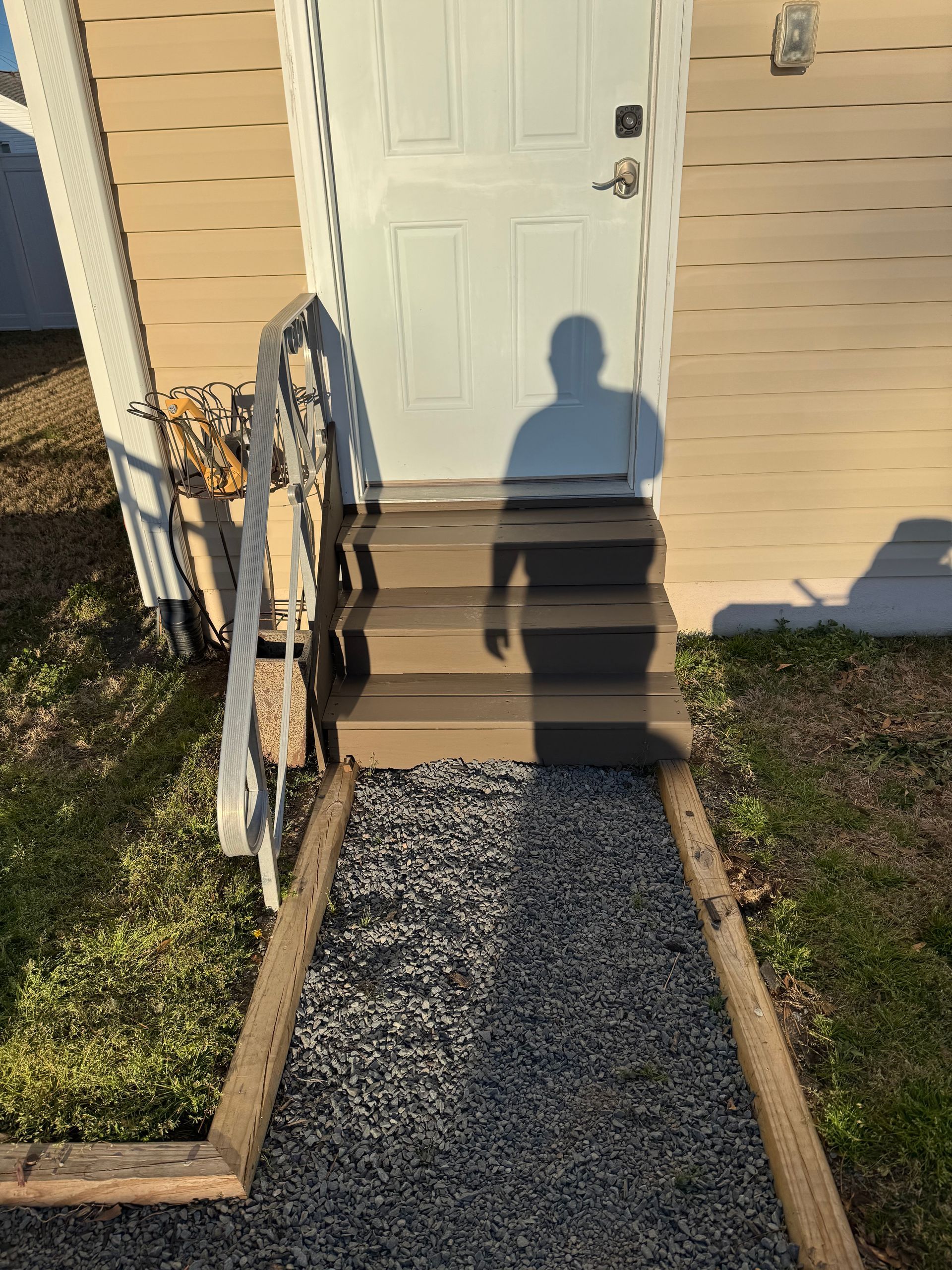 Door with steps leading up, gravel path