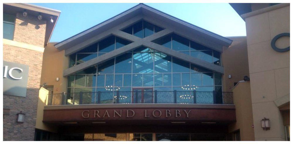 Exterior of a building with a large glass facade above the words