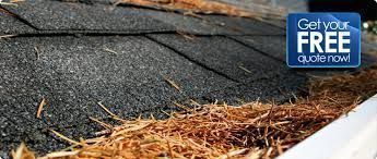 A roof with shingles and a gutter filled with debris, a blue square with text