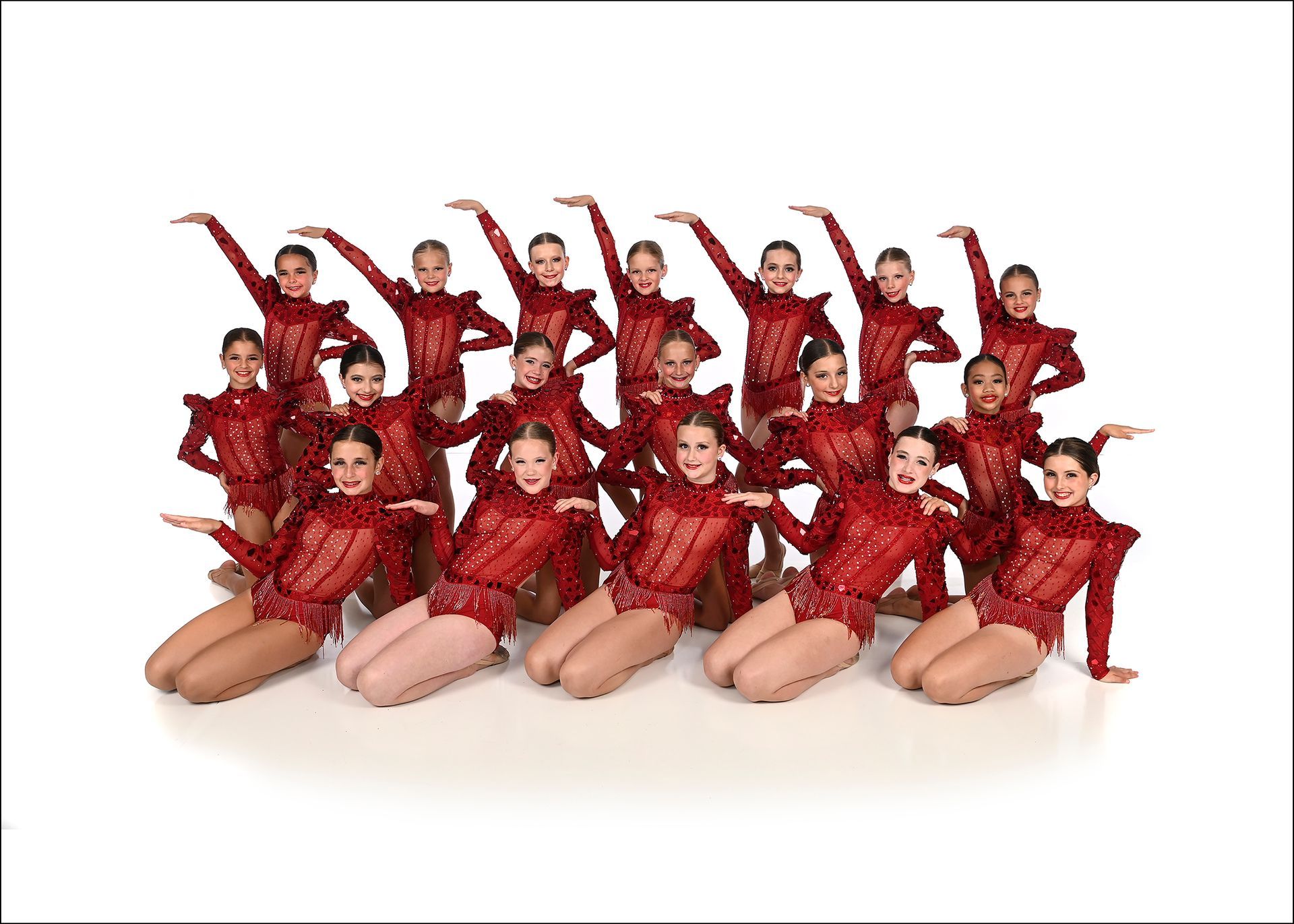 A group of young girls in yellow leotards are posing for a picture.