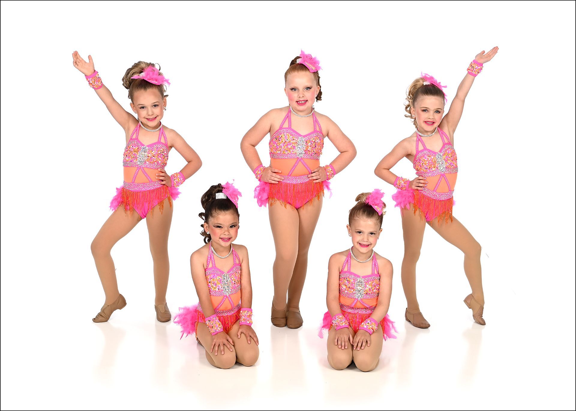A group of young girls in blue and yellow costumes are posing for a picture.