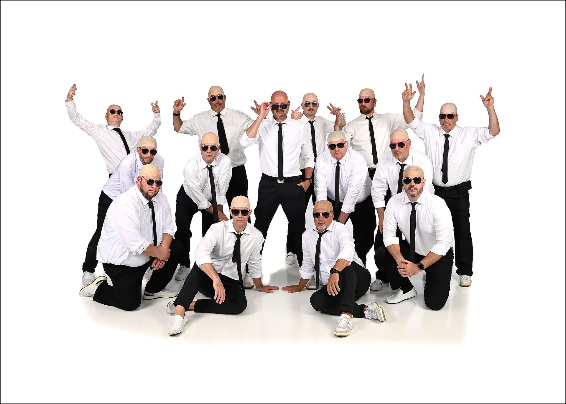 A group of men are posing for a picture in front of a boombox.