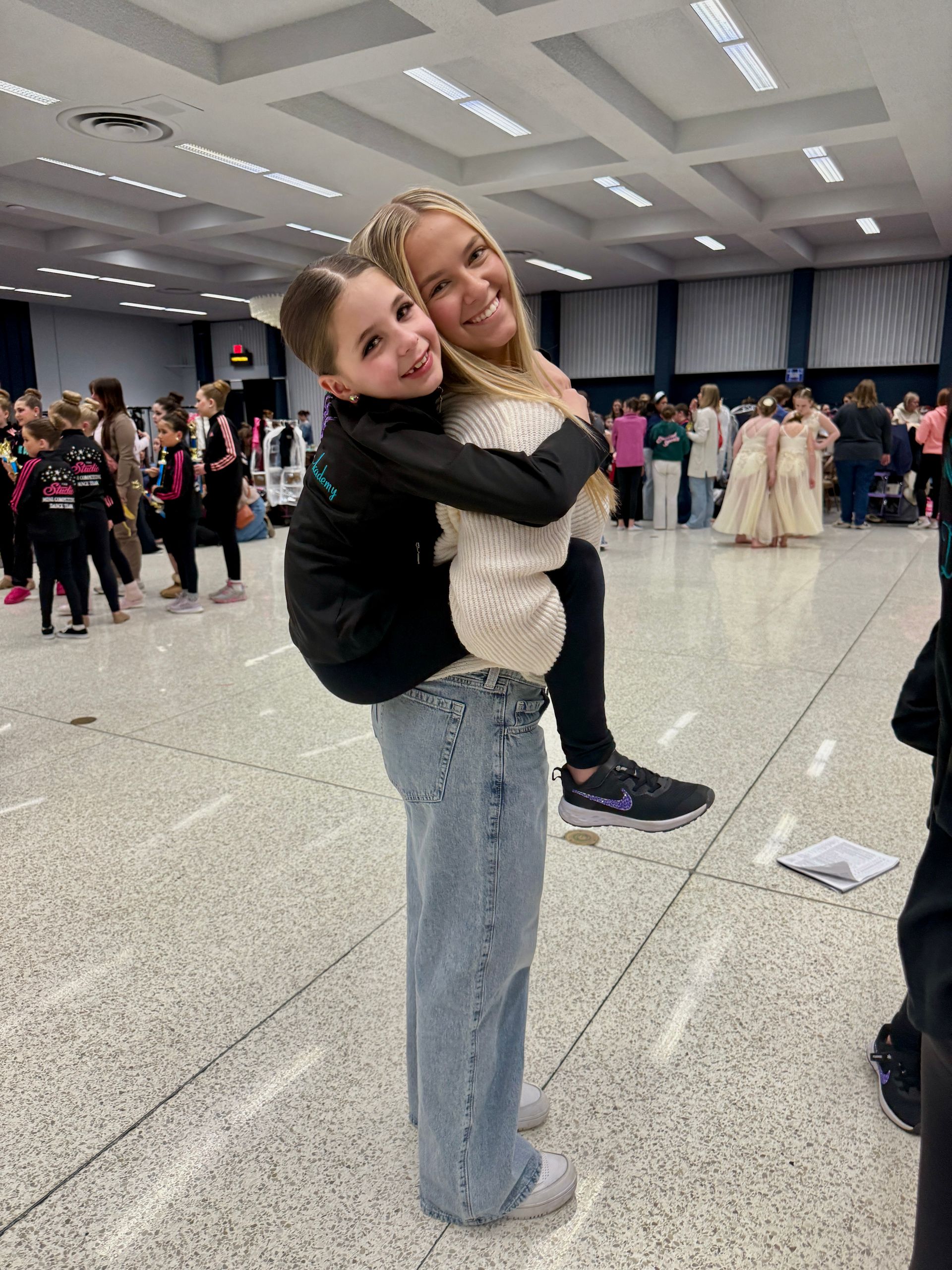 A woman and a girl are posing for a picture together