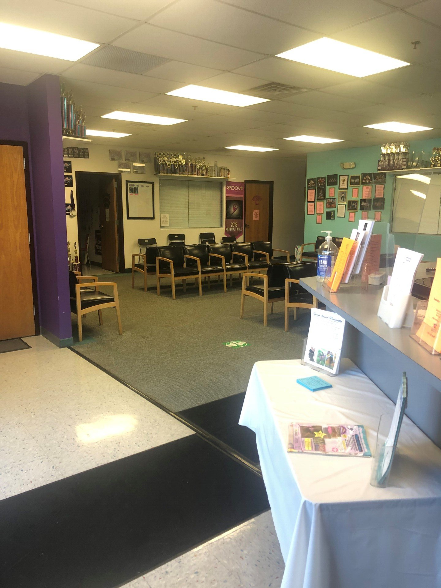 A large room with a table and chairs in it.