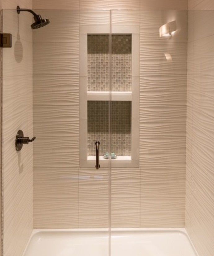 Bathroom shower with beige tile, dark fixtures, and a small window in the back wall