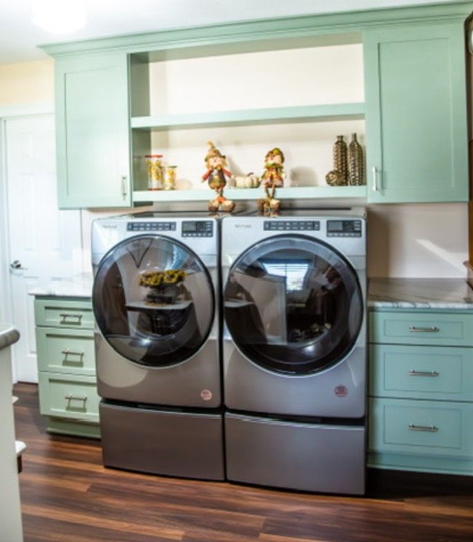 Mint laundry room with front-load washer and dryer and open shelving above