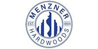 Company logo for Menzner Hardwoods, featuring circular text and a central abstract wood profile icon in blue on white.