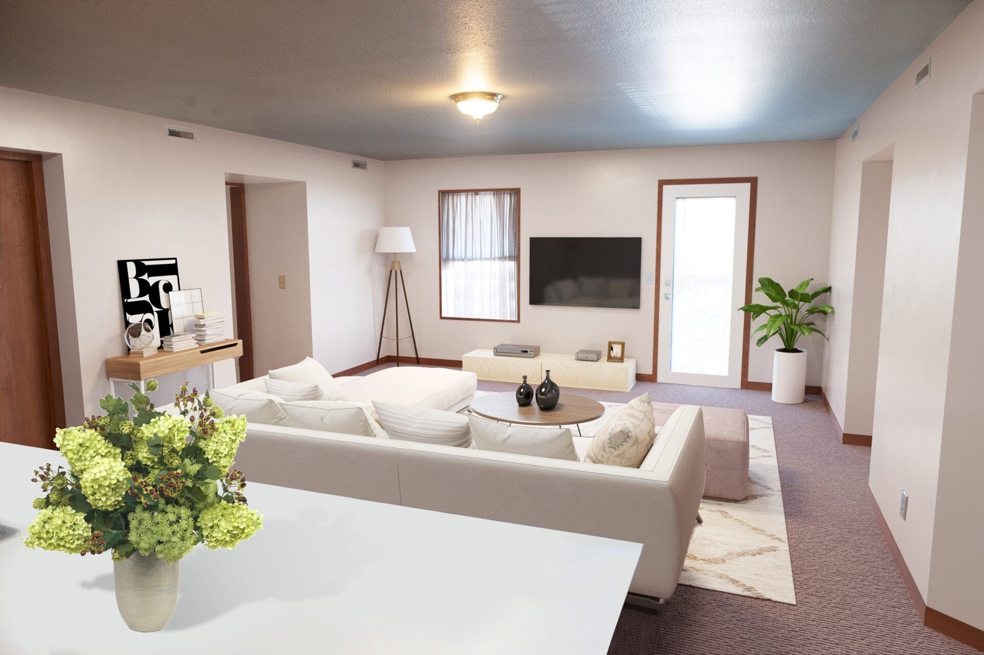 A living room with a couch and a flat screen TV.