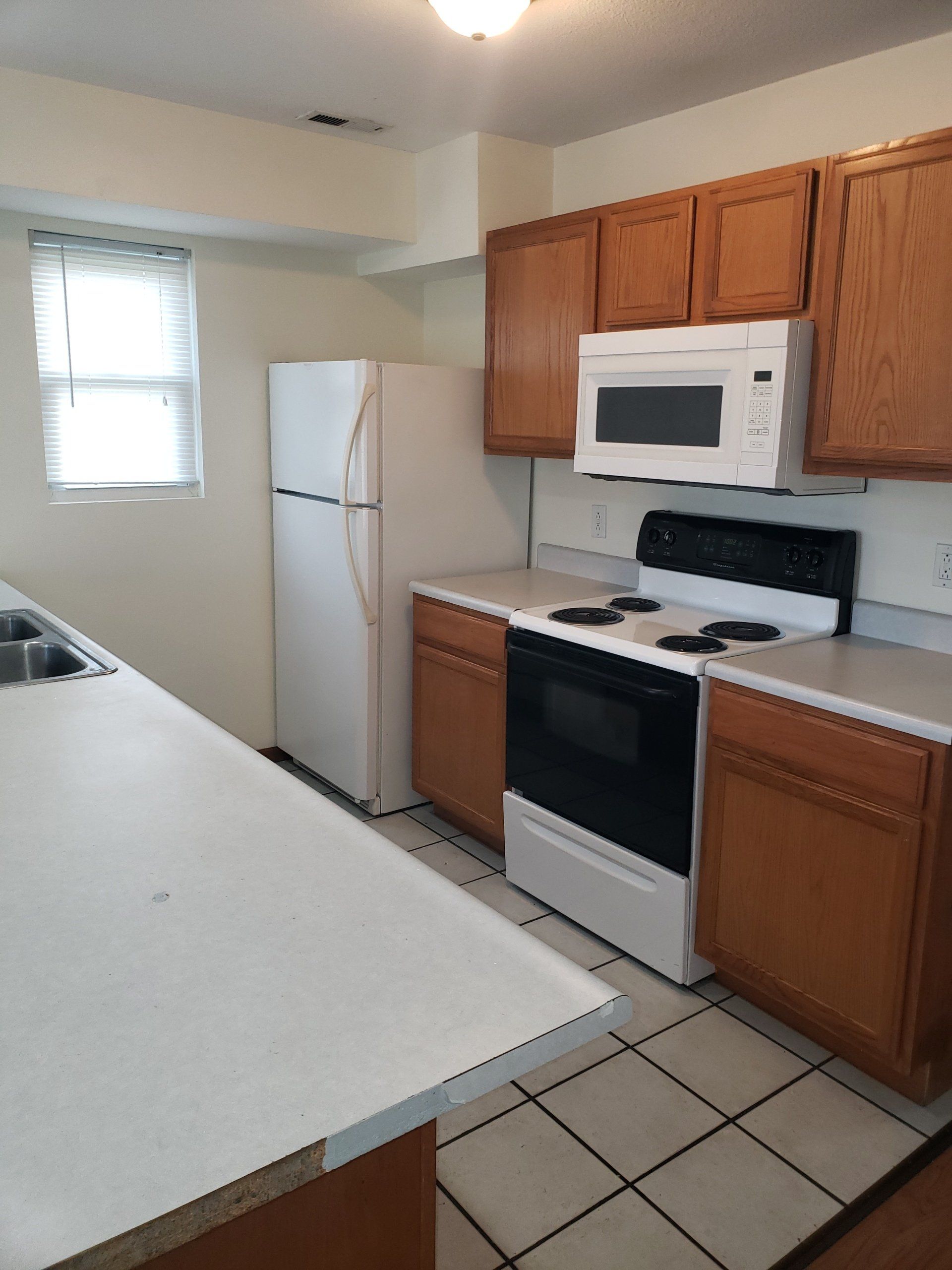 A kitchen with a refrigerator stove and microwave.
