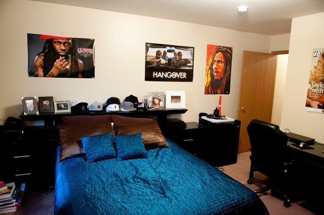 A bedroom with a bed and a poster that says hangover.