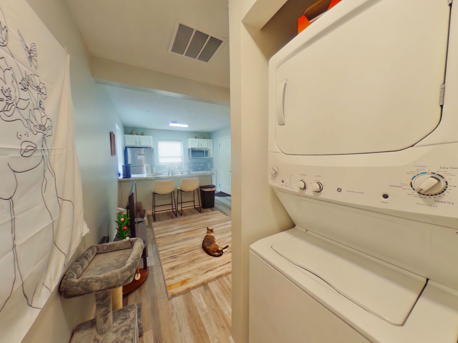 A washer and dryer are stacked on top of each other in a laundry room.
