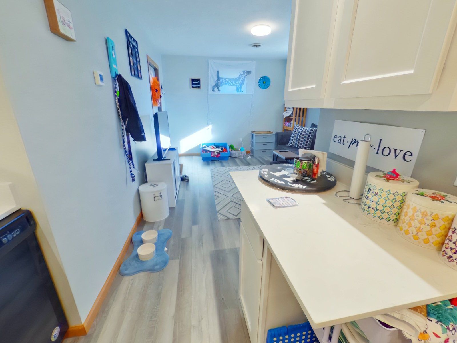 A bathroom with a toilet, sink, and washer and dryer.