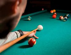 A man is playing pool.